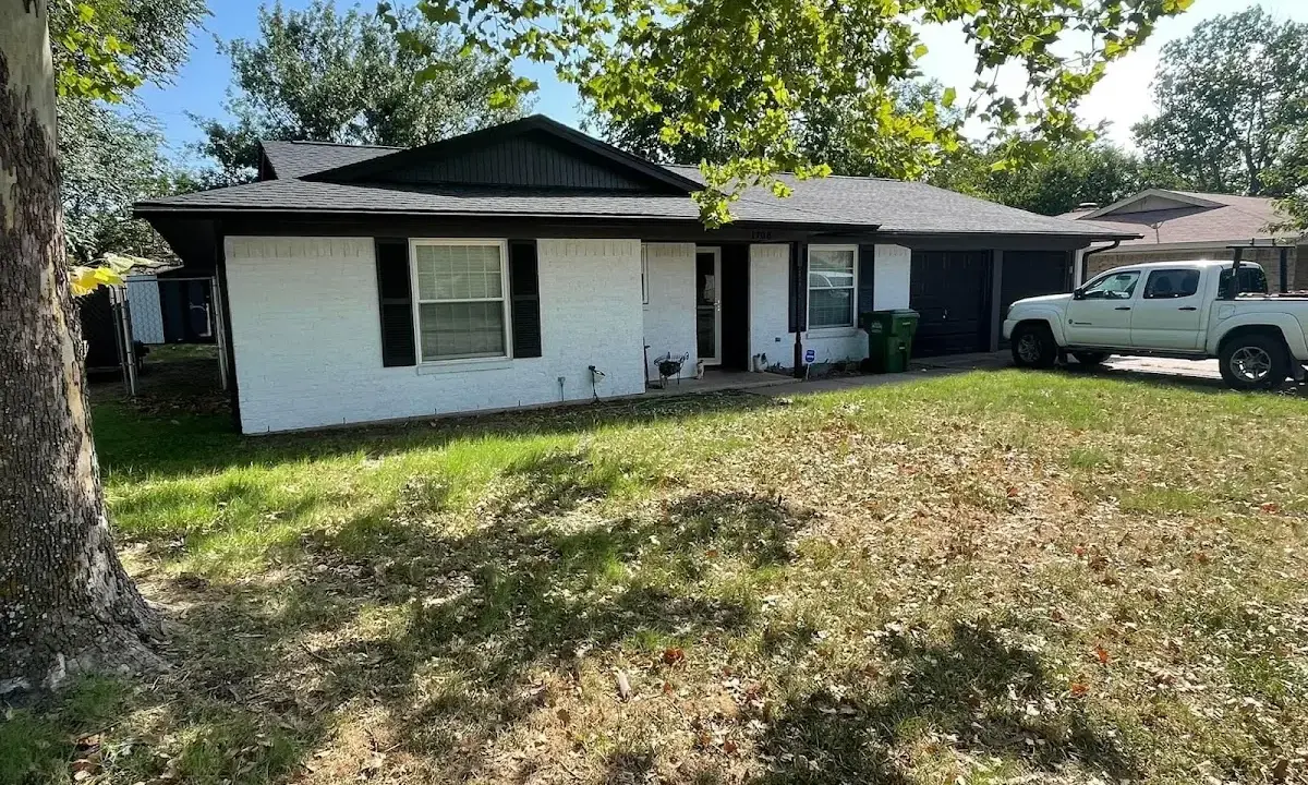Professional roofing crew working on a residential roof in Carver